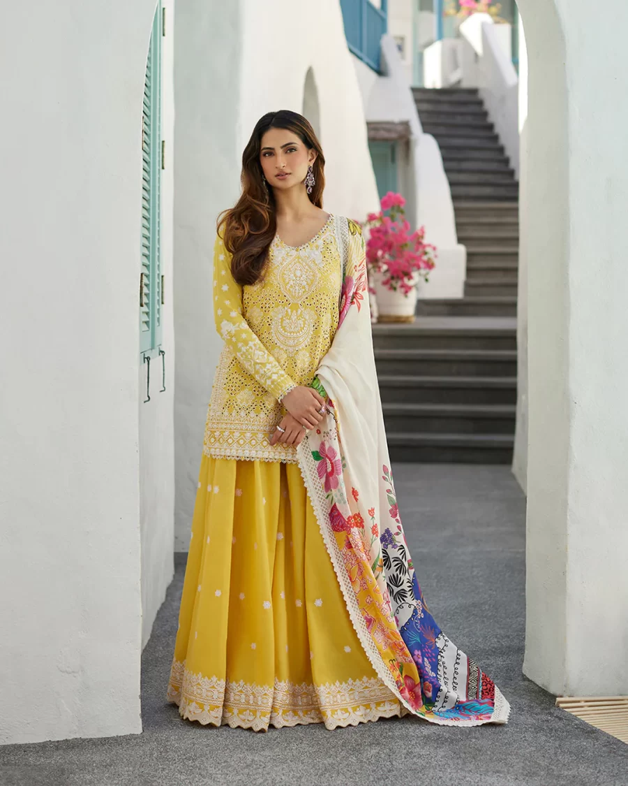 Discover elegant Pakistani suits online at FabCollections. Talin features detailed thread work on yellow schiffli lawn with a tropical silk dupatta.