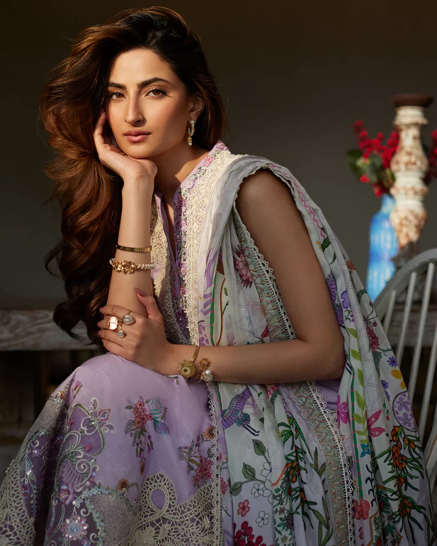 Discover elegant unstitched Pakistani suits online at FabCollections. Nazeli features delicate pink motifs on lilac lawn with an ornate silk dupatta.